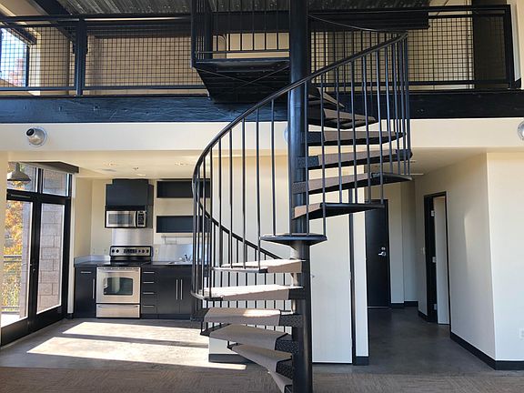 Spiral staircase leading to upper mezzanine / bedroom