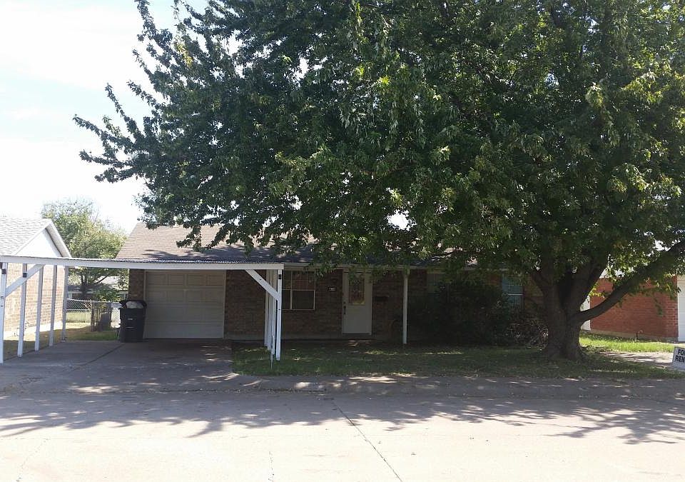 carport and beautiful Maple tree provide ample shade to the 