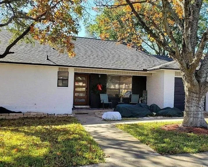 Front of home, recently painted white and chocolate.