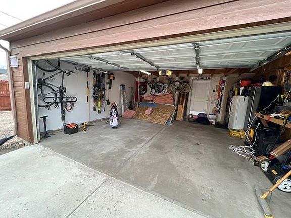 2 car garage with plenty of storage in the rafters and workbench for tools and bicycles. 2 additional off-street parking spots (not shown) to the left.