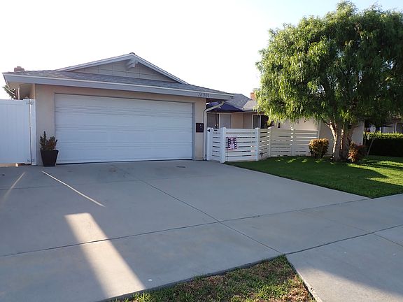 Spacious driveway, 2-car garage, shade tree, enclosed patio