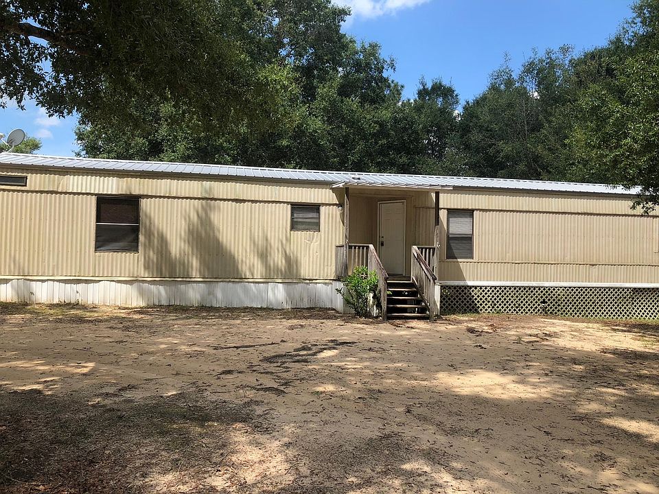 Shaded Front View with Covered Porch & Metal Roof