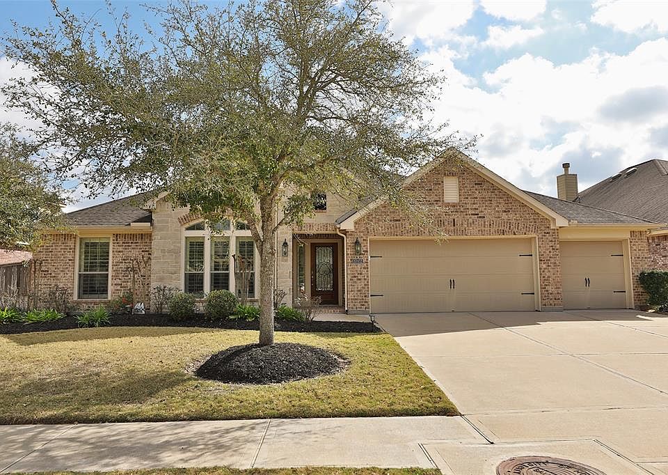 Gorgeous Cinco Ranch home built by Perry Homes. Stone and brick enhance the stylish elevation as well as maturing trees and attractive landscaping. The extra wide driveway allows for plenty of parking space for family and guests.