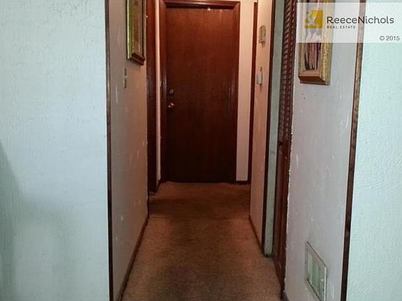 Hallway leads to 3 Bedrooms and Bath, has furnace/AC, Hot Water Tank Closet.