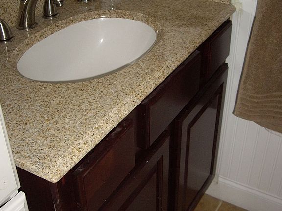 Newly renovated master bath with granite countertops, tile, and new cabinets