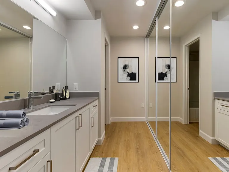 Bath with white cabinetry, grey quartz countertops, and hard surface flooring (Select Home)