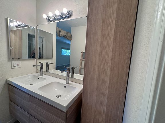 the vanity and storage of the first master bedroom