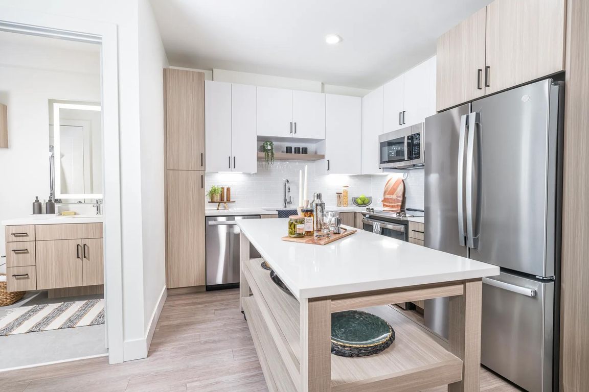 Creating culinary magic with a chef's dream island complete with ample storage, found in the heart of Modera Golden Triangle, Denver, Colorado.