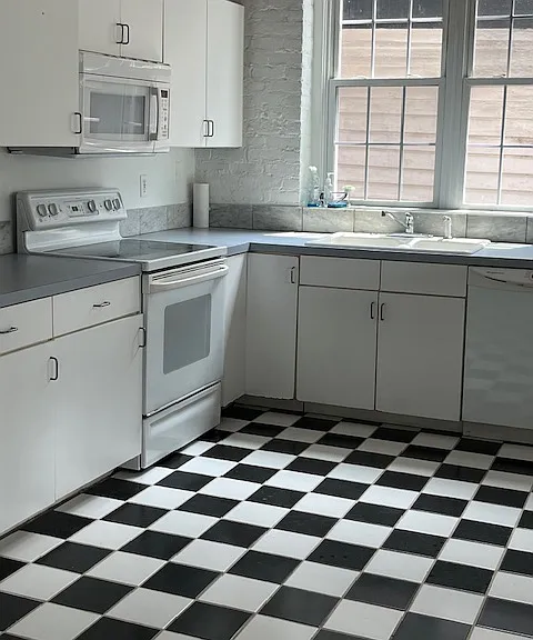 Kitchen equipped with a stove, microwave, dishwasher and refrigerator with lots of cabinet space.