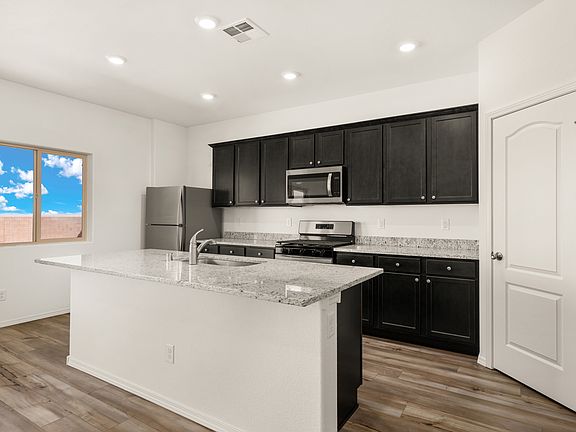 The kitchen has granite countertops and a spacious island.