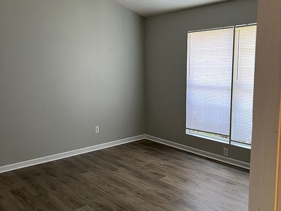 Master bedroom with blinds closed (this shows the paint color well, which is a light grey)
