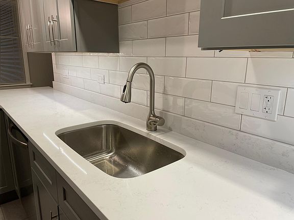 Kitchen with quartz countertops, backsplash, Stainless Steel faucet and SS under-mount sink with under cabinet lighting