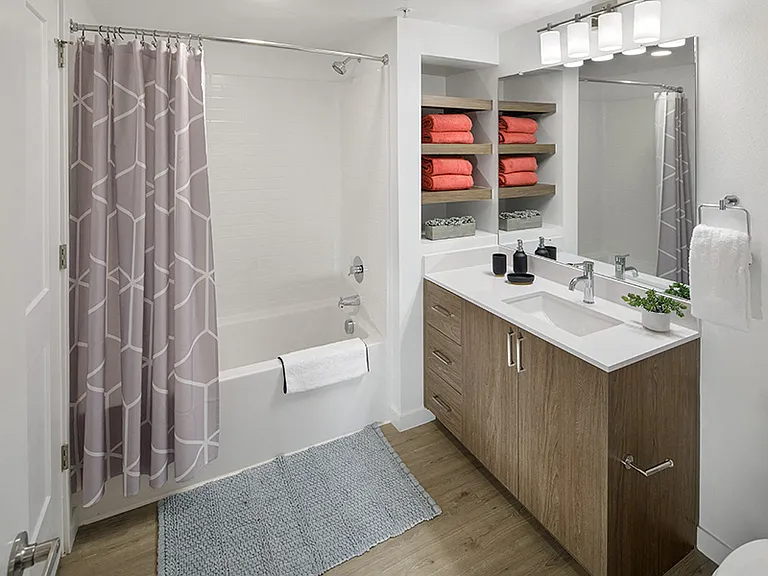 Modern bathrooms include soaking tubs with tile surround and built-in shelving