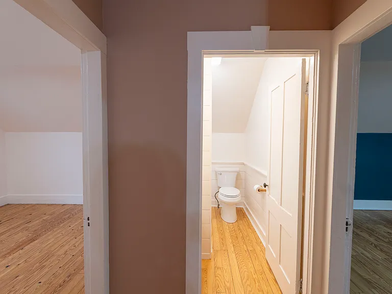 Ample landing at the stair with bathroom in the middle, the larger bedroom with walk in closet to the right and smaller bedroom to the left.