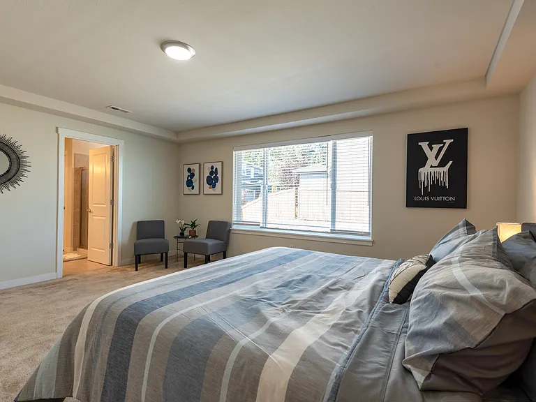 Another view of the Primary Bedroom. Private bath with walk in shower double vanity sinks