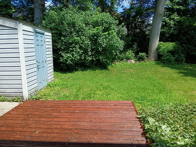 Backyard, flower/vegetable garden, deck, and storage shed