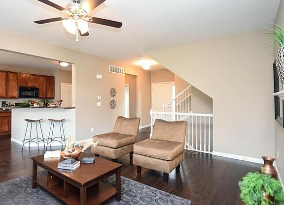 Breakfast bar can accommodate 2-4 stools. Staircase to upper level and lower level in the back ground. Hallway to back left leads to half bath, large laundry room and fully insulated garage.