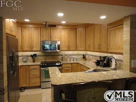 Updated kitchen, granite counter top, top of the line stainless steel appliances, custom tile work, breakfast bar, generous cabinet space.