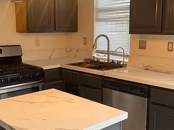 Lovely updated kitchen with gas stove, dish washer and microwave.