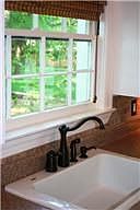 renovated kitchen with tumbled travertine backsplash