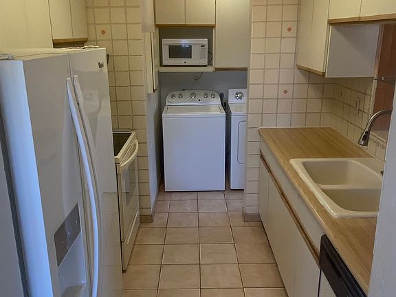 Kitchen with view of laundry room
