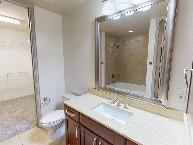 Apartment Bathroom with large soaking tub and Tile Flooring.