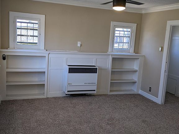 Living room with built-in bookshelves and a huge storage closet