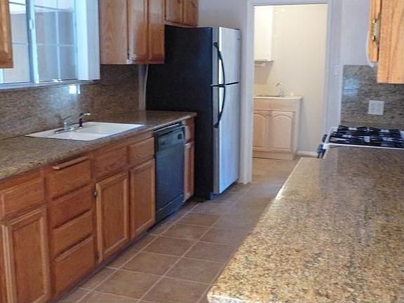 Kitchen recently updated with slab granite counters and all new appliances