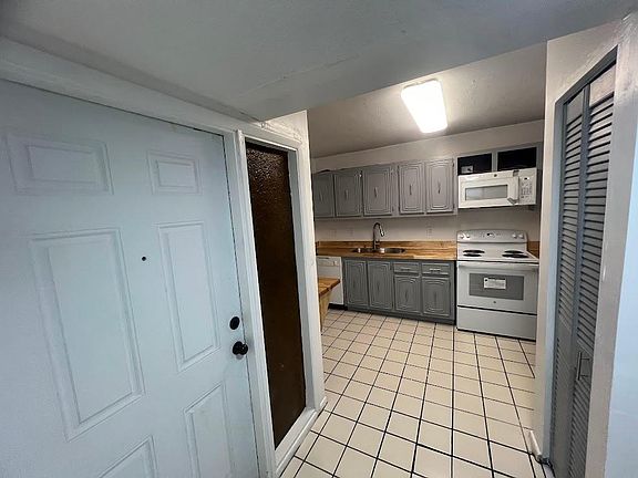 Front door entry with kitchen to the left