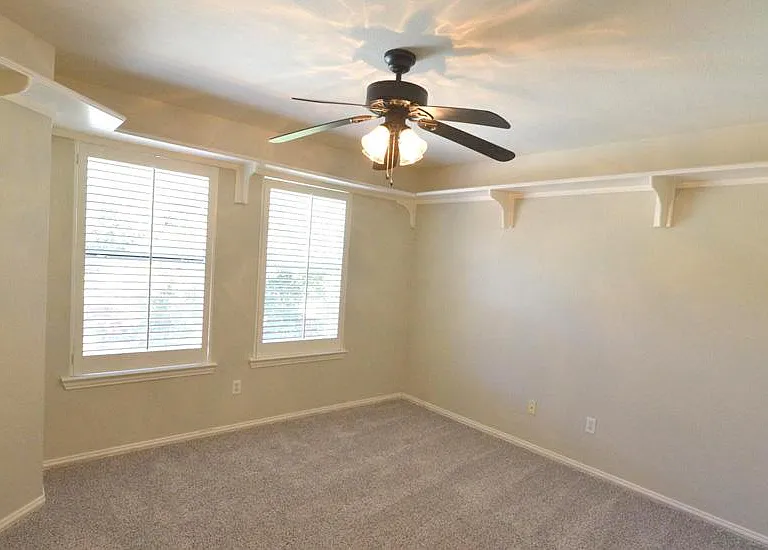 One of the 3 upstairs bedrooms with wrap around ceiling shelves