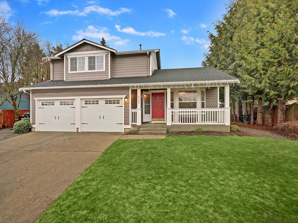 Covered front porch and carriage doors welcome you home in this friendly neighborhood. RV parking is on gravel on the left side of the driveway.