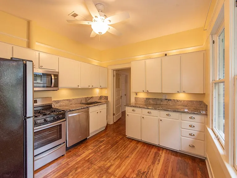 Cooks kitchen with mix of original and new wooden cabinets.