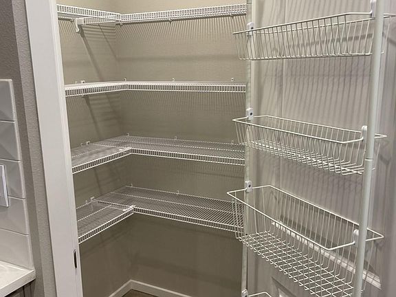 Walk in pantry with extra door storage.