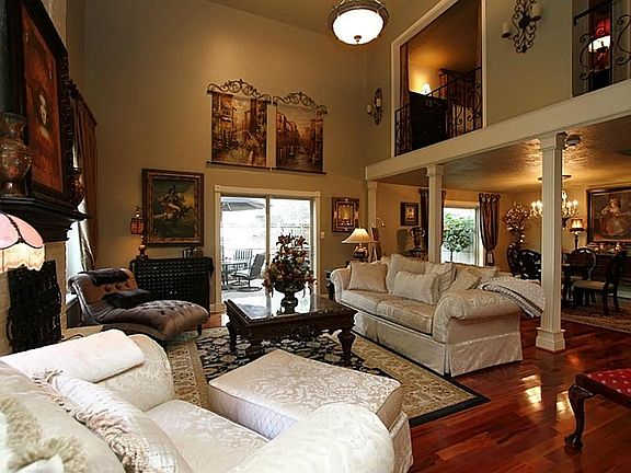 ...fluted wood columns, extra tall baseboards, alabaster chandelier with custom decorated medallion.