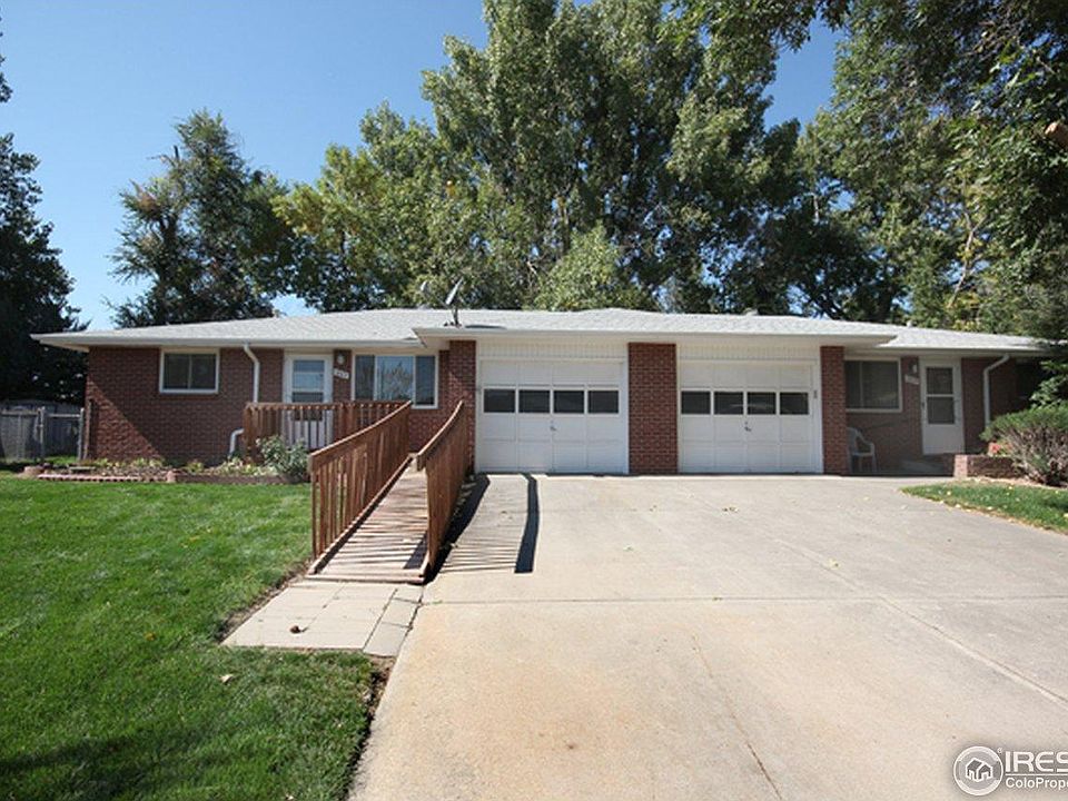 1807 Hilltop Court is the left half of this well maintained duplex with mature trees and a one car garage. The ramp has been removed since this picture was taken.