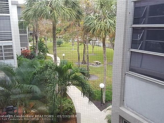 Bedroom window view - garden & path to bridge, pool & clubhouse