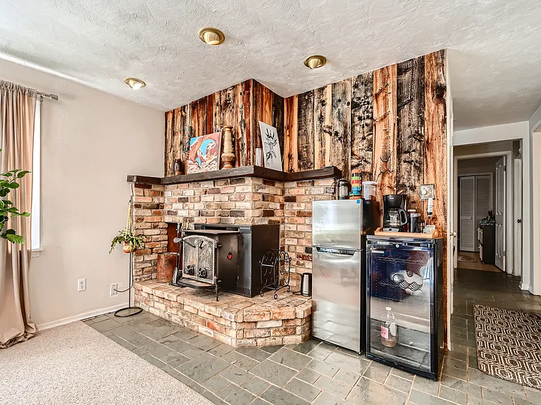 Rustic wood burning stove and wine cooler. Lower level area