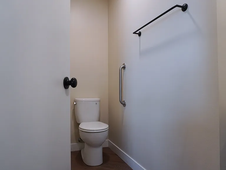 Master bathroom featuring a stand-up shower and toilet, offering both functionality and comfort.