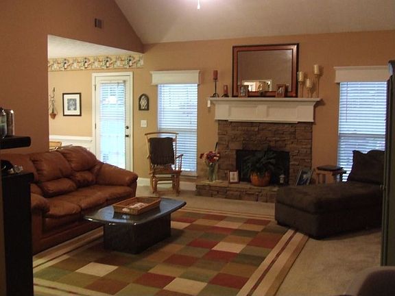 A beautiful stacked stone fireplace with glass doors in the great room