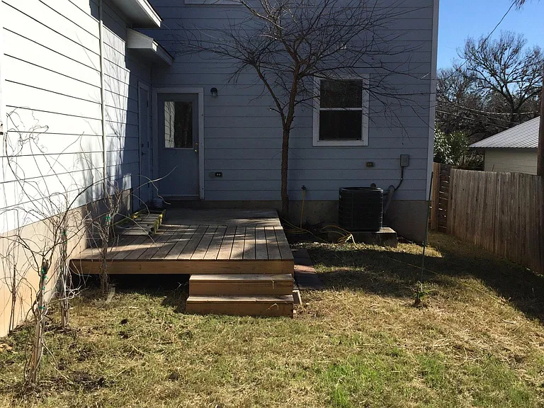 Private fenced backyard with deck
