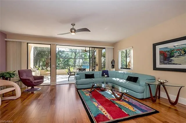 Living room opens to your rare oversize screened balcony.