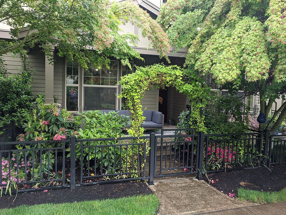 Front of townhouse and fenced in porch.