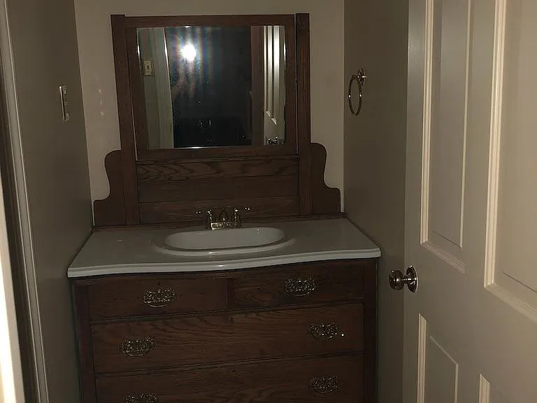 Oak Dresser repurposed in hall bath with shower upstairs.