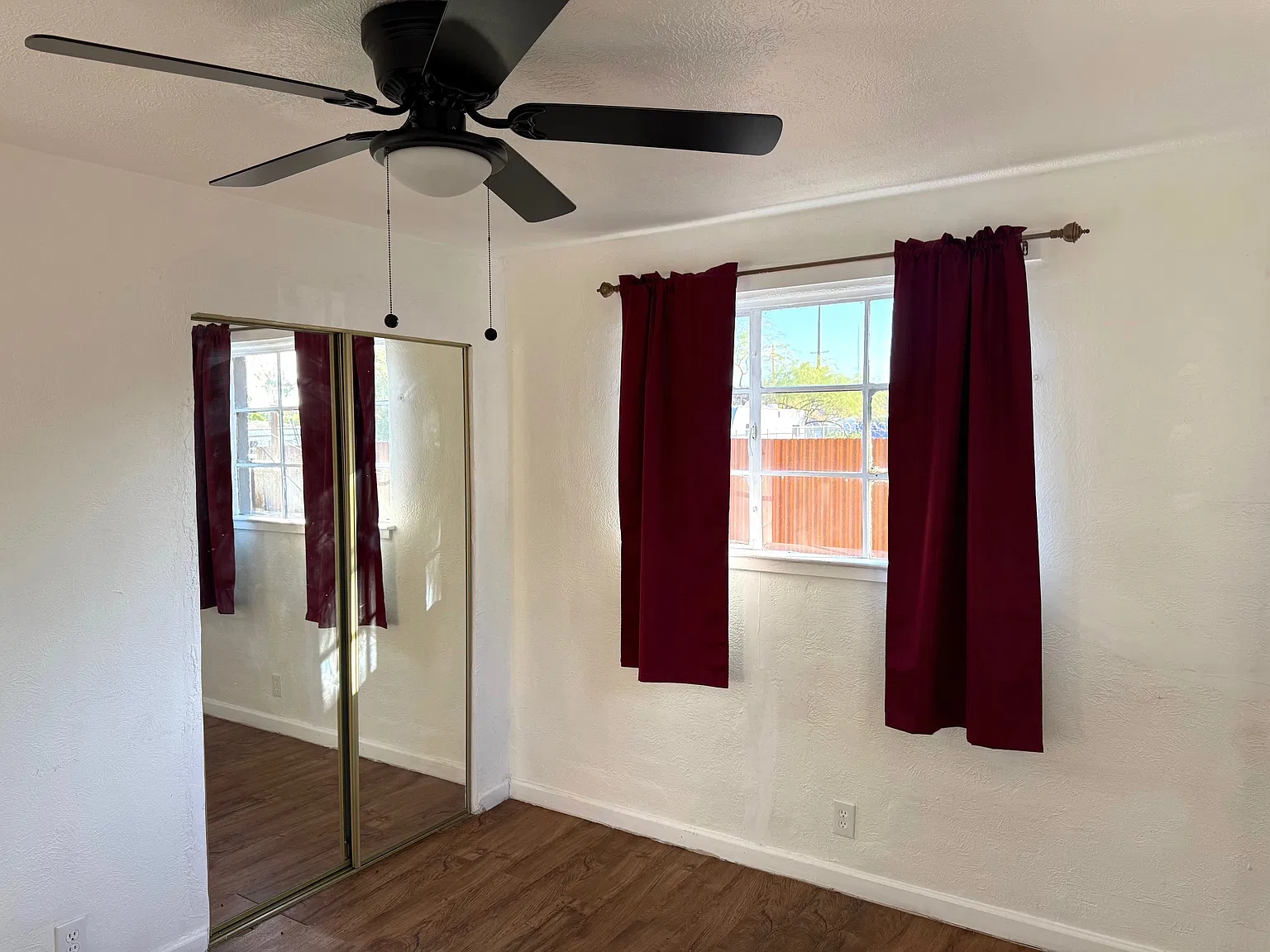 Both bedrooms have ceiling fans, large windows and mirrored closet doors