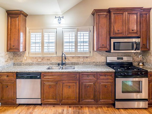 Kitchen includes garbage disposal, stainless gas stove, microwave, dishwasher and refrigerator. Granite countertops.