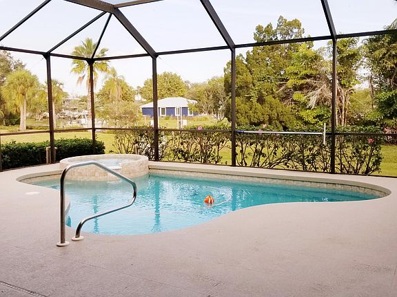 Caged lanai, heated pool with cake stairway, spill over hot tub, auto vaccuum.
