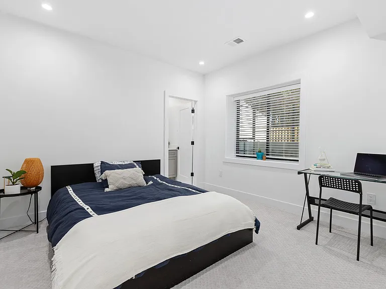 Bedroom B with a queen size bed, office furniture, spacious walk-in closet/storage, and full bathroom