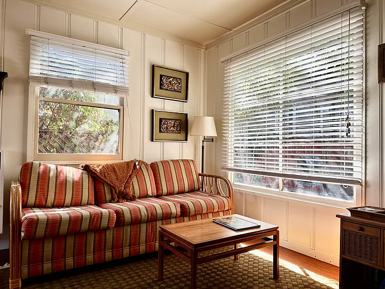 living room with large windows that look out to private outdoor oasis