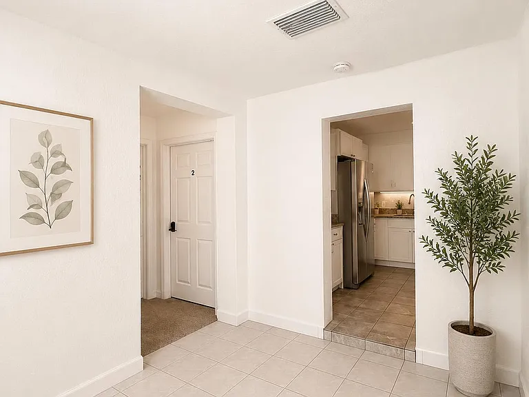 Open tiled entry area connects to the kitchen and adjacent rooms, offering easy flow and space for everyday storage.