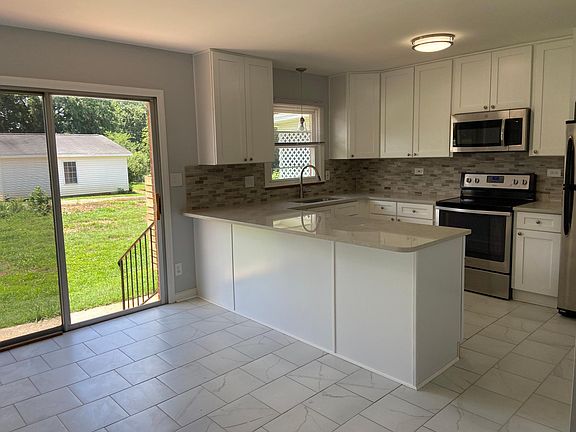 Kitchen, sliding glass door and dining room.